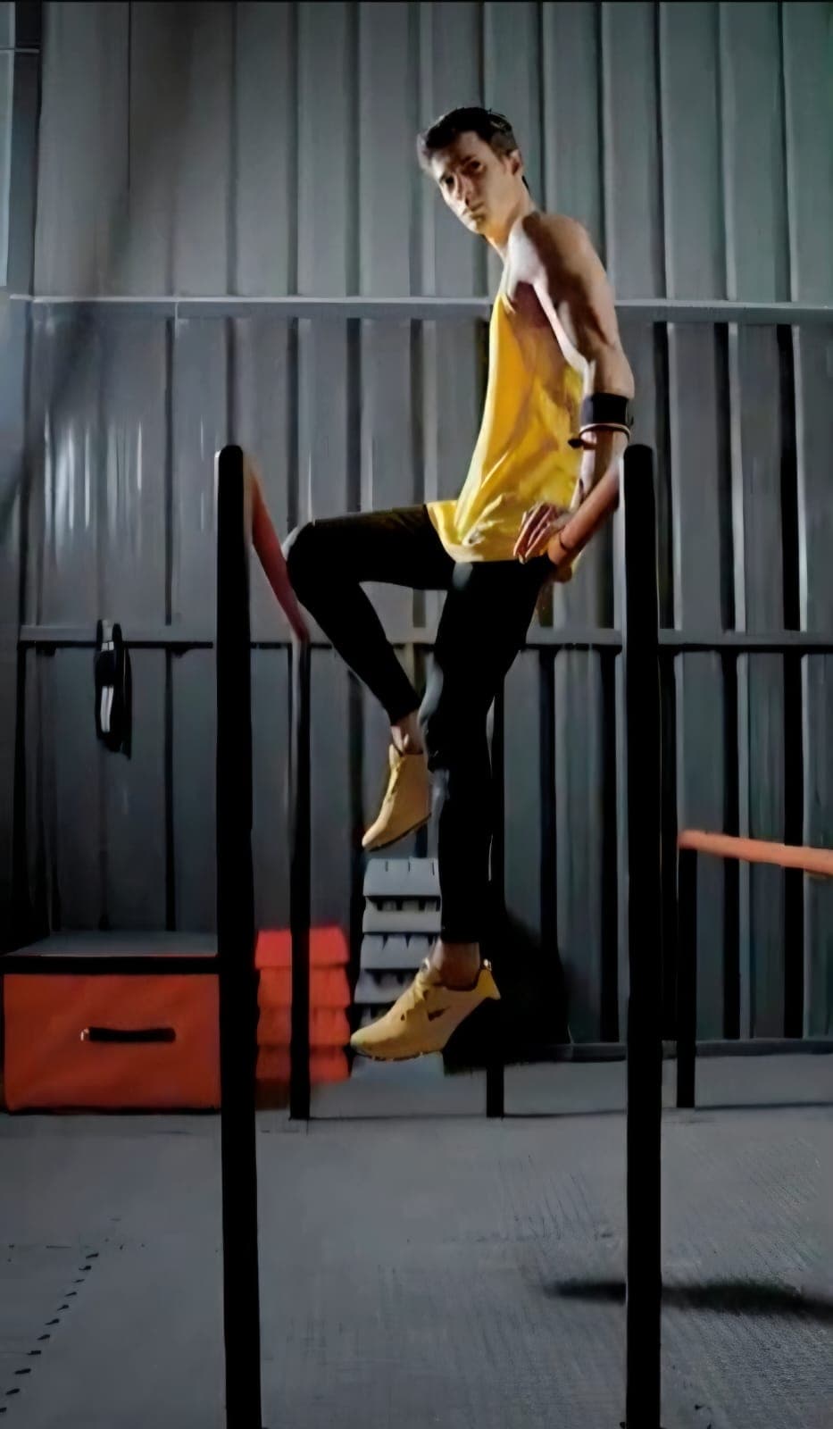 Athlete on parallel bars in an industrial gym