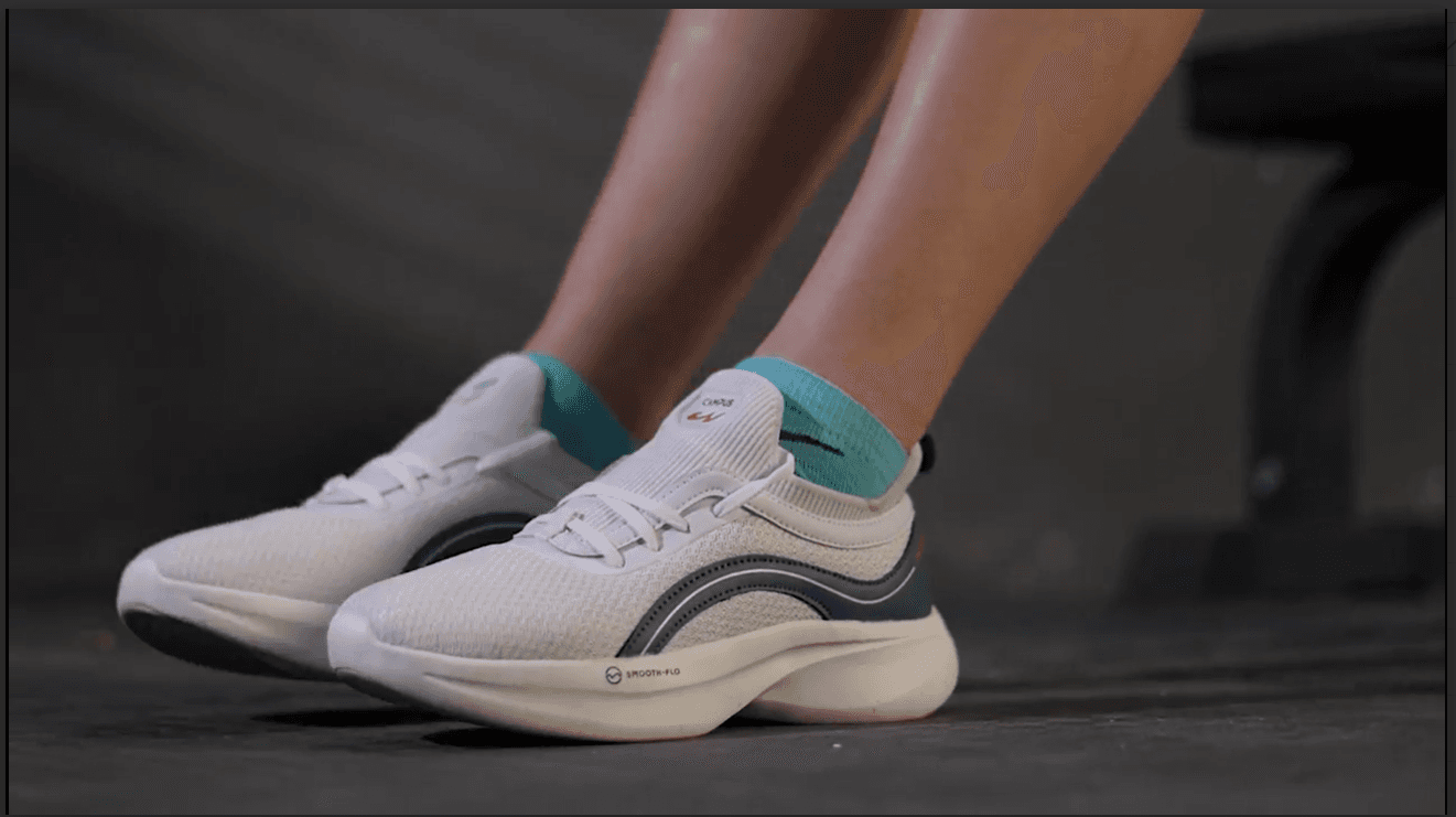 White running shoes beside a gym bench