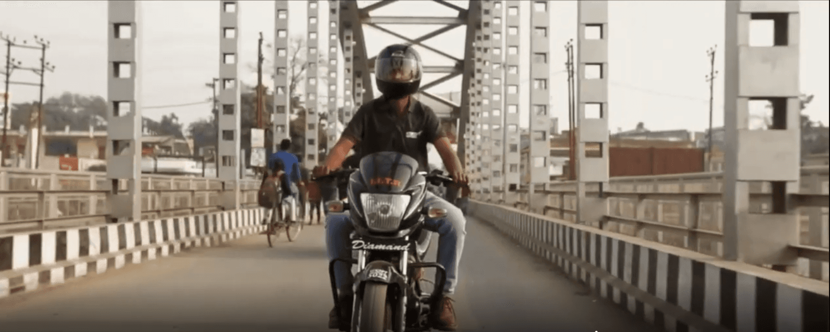 Rider crossing a truss bridge
