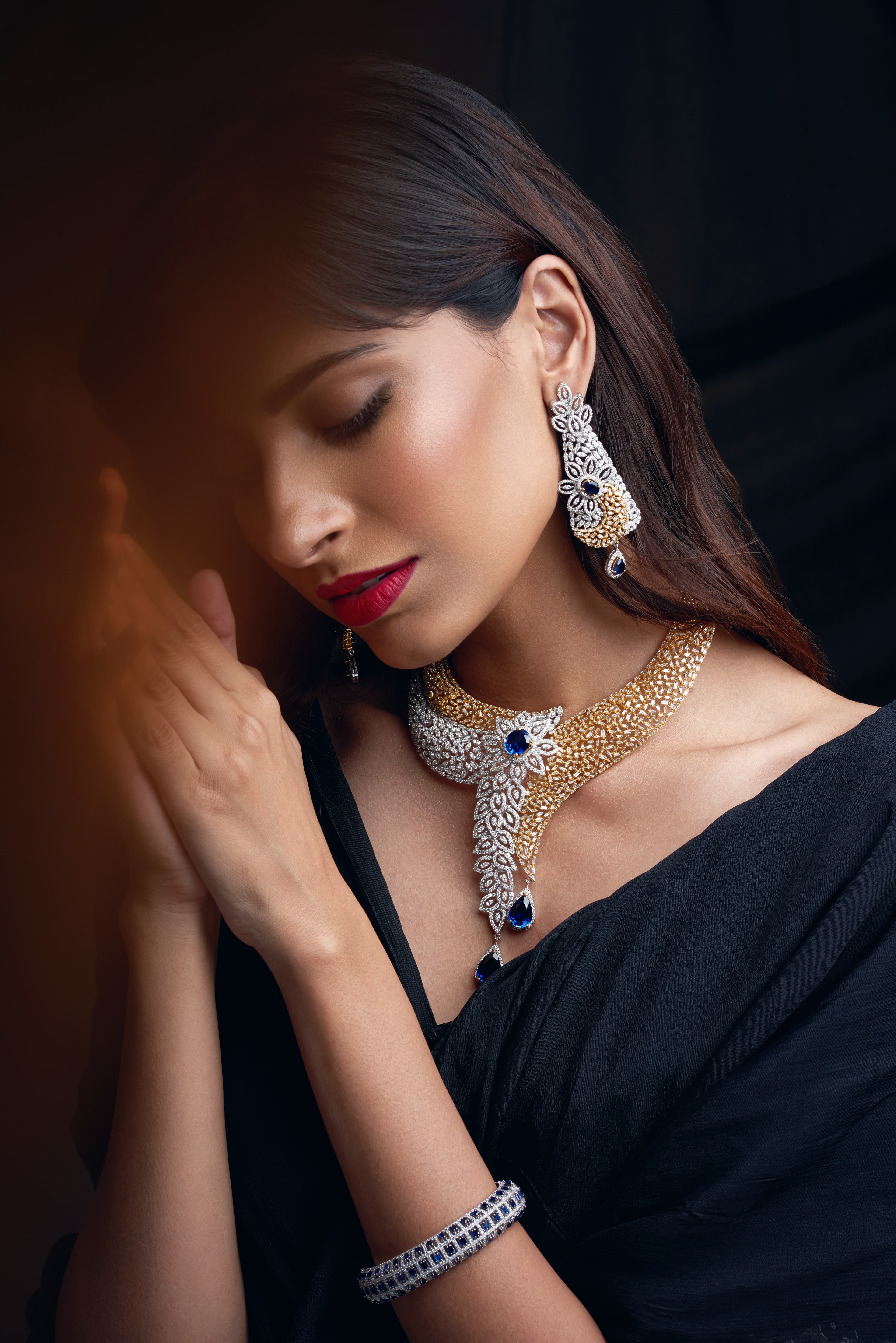 Jewellery campaign portrait with gold-diamond collar and black saree