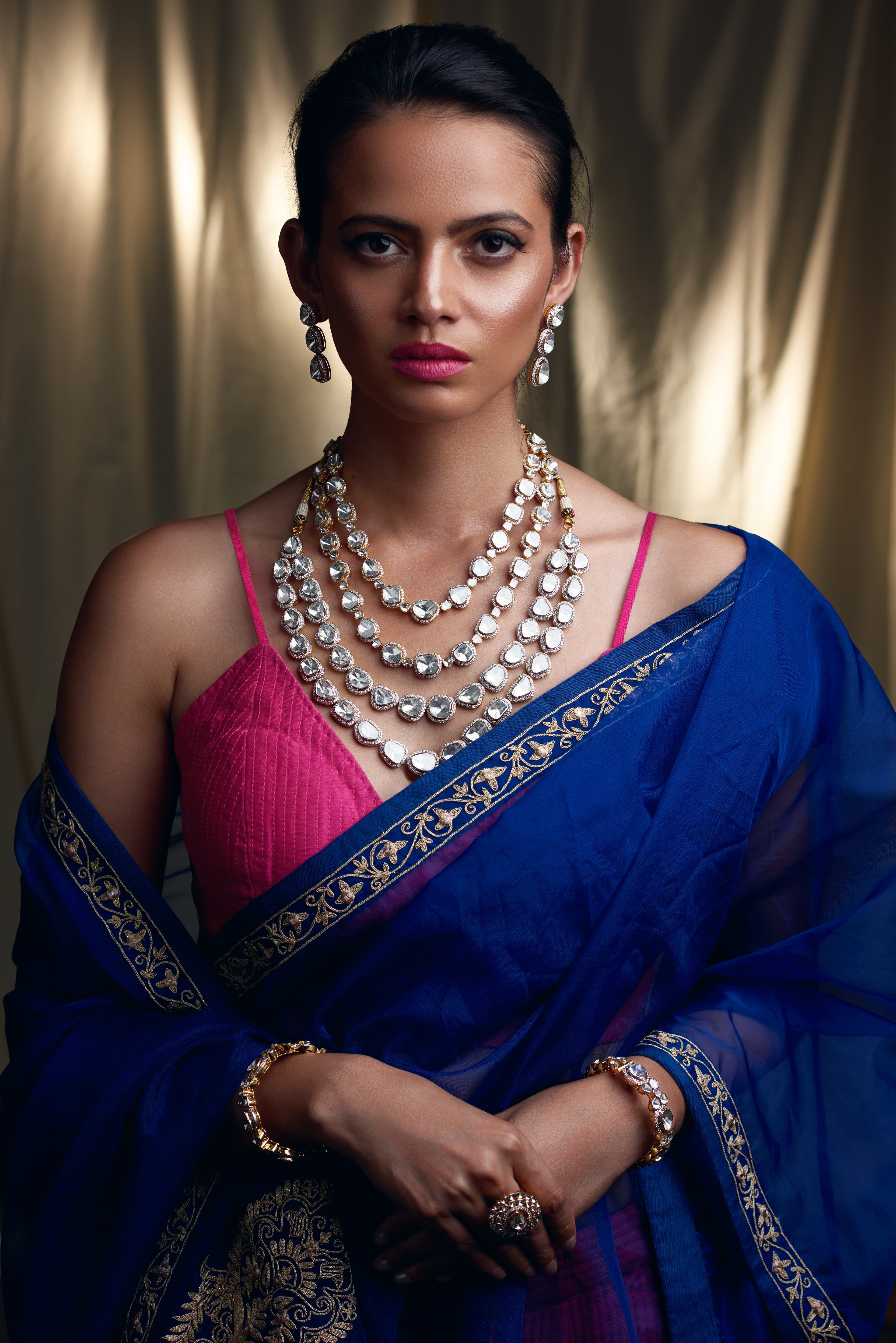 Polki diamond necklace with a royal-blue saree